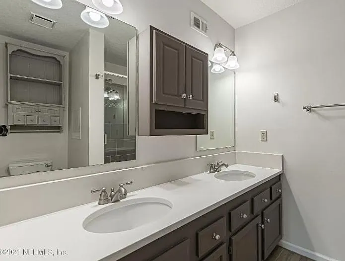 Quartz countertops and lots of storage in master bathroom.