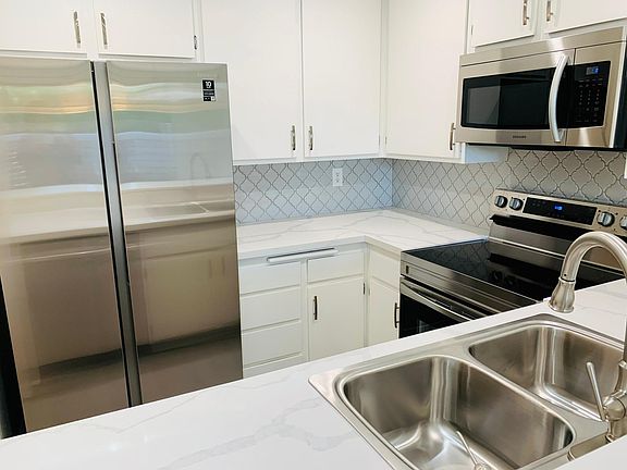 Stainless steel appliances and quartz counter tops