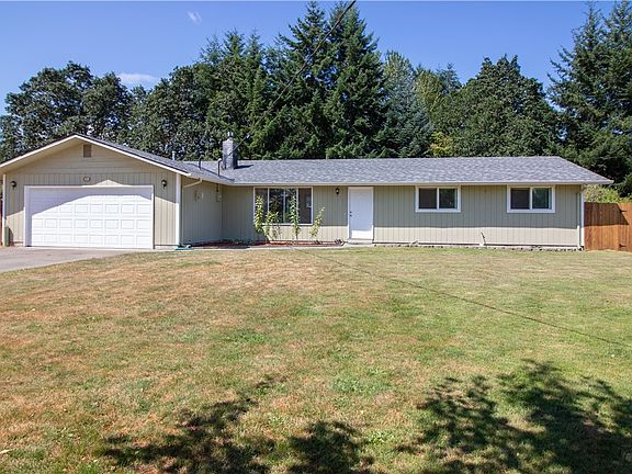 Beautiful front yard with 2 car garage and an apple tree