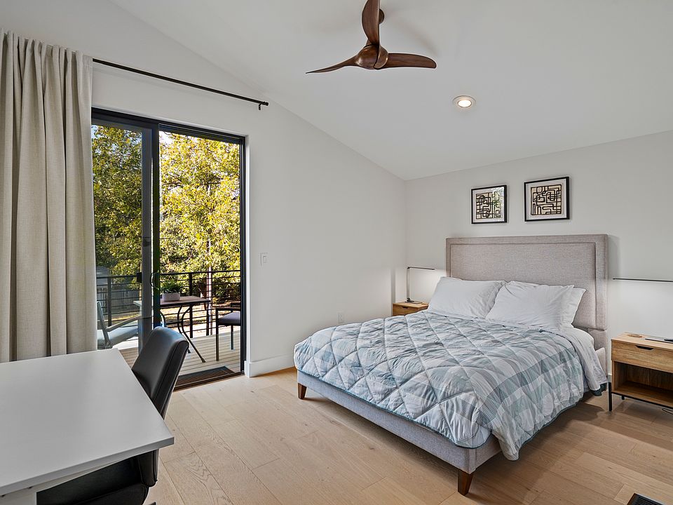 Large bedroom with a home office, closet and an access to a private balcony.