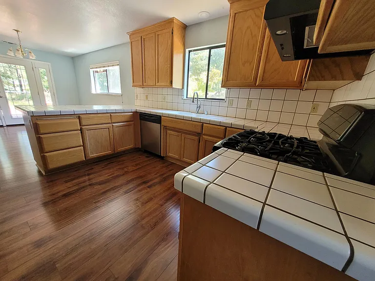 The kitchen has NEW White Granite, and cabinets have been painted White.