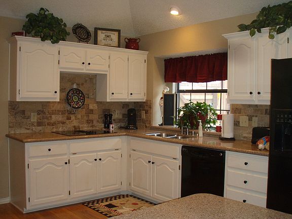 good sized kitchen updated with quartz countertops, travertine backsplash,more