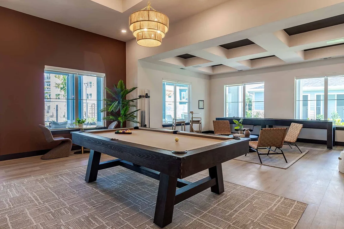 Rack 'em up in the resident game room, featuring a billiards table and comfortable seating for friendly competition any time.