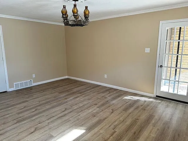 Master suite features built-in hardwood bookcase, Spanish light fixture, door access to patio and access to master bath and separate vanities and walk-in closets.