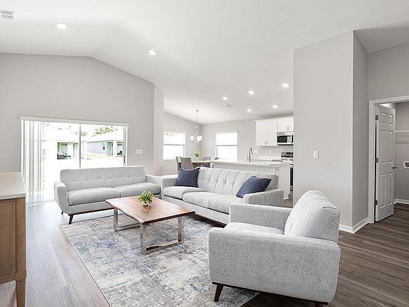 Enjoy a sunny, open living area with volume ceilings and LVP flooring.