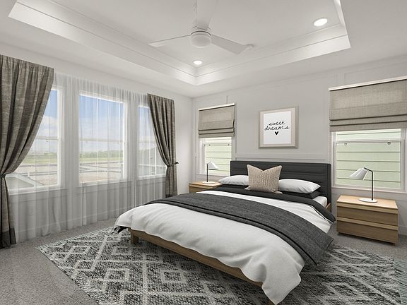 Primary suite with decorative feature wall tray ceiling