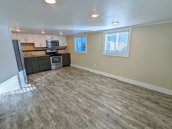 Living room, kitchen, and windows along south wall.