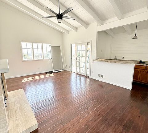 Light-filled upstairs living room with two balconies that open up to breathtaking views stretching from Mission Bay to the ocean.