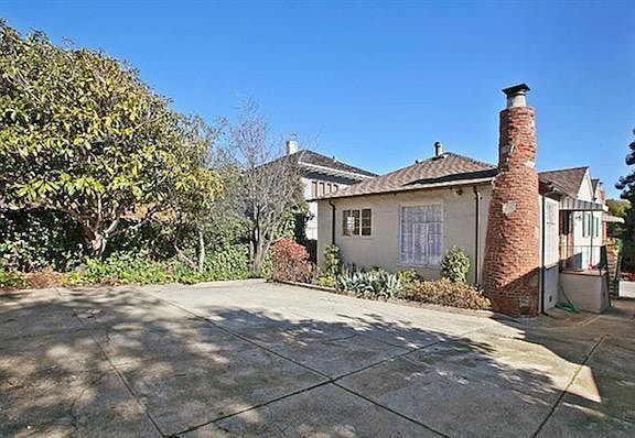 Back of property from the carport. This is the unit for rent with a side garden and path in front of the windows.