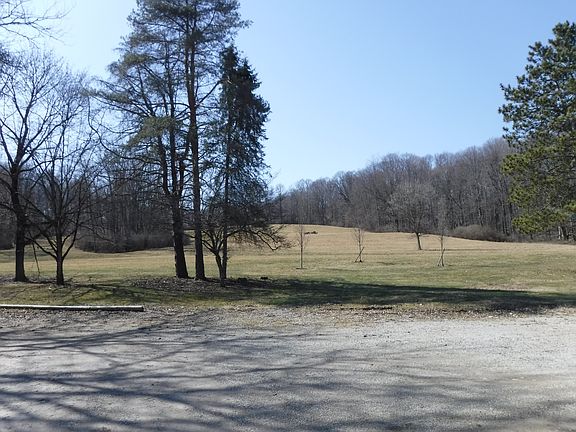 Off street parking and view of farm behind the unit