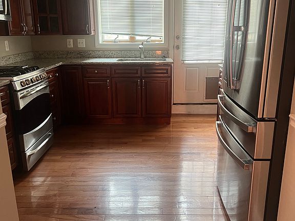 Stainless steel appliances. Kitchen leads to back patio