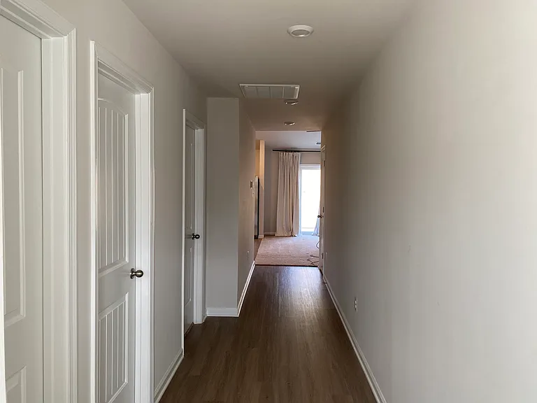 Hallway from front door to bedrooms, bathrooms, living room and kitchen.