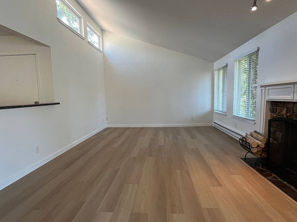 Spacious Living room with high vaulted ceiling, oversized windows.