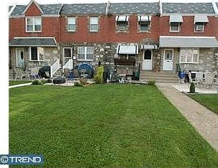 Magnificent Front Yard with Cement Patio.  Stone and brick front with vinyl. 