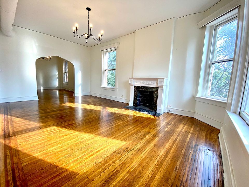 Front room/living room featuring 12-foot ceilings, a fireplace, PLENTY of space and LOTS of gorgeous sunlight!