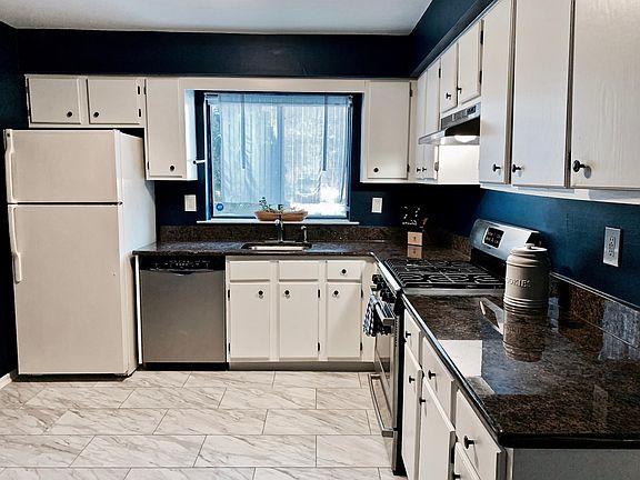 Kitchen - brand new flooring, freshly painted cabinets, gas stove.