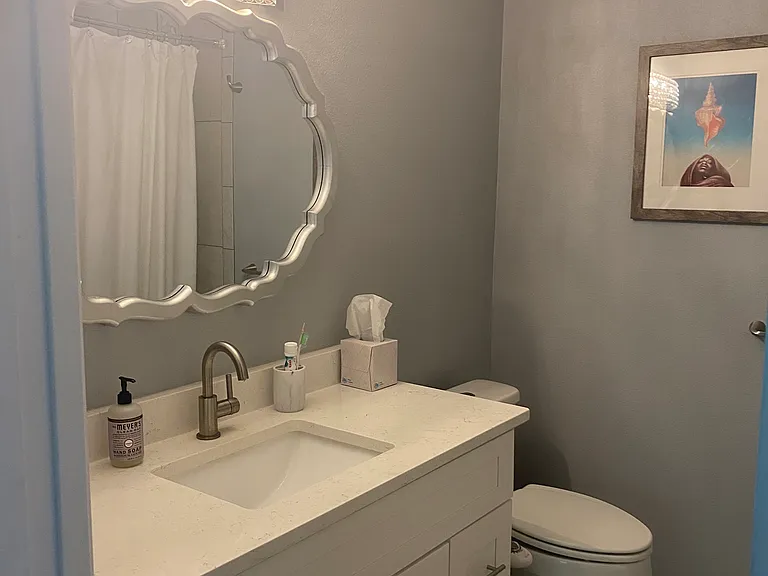 Guest bathroom with bidet on toilet.
