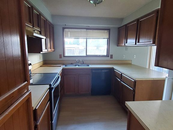 Kitchen with plenty of cabinet space. Dishwasher and electric stove.