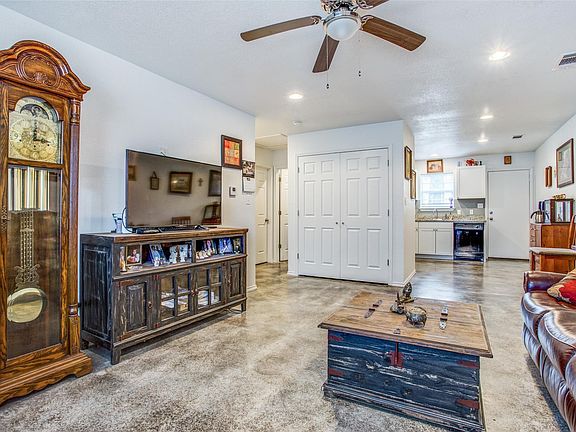 A view from the livingroom towards the kitchen and the enclosed laundry area (full size laundry connections)