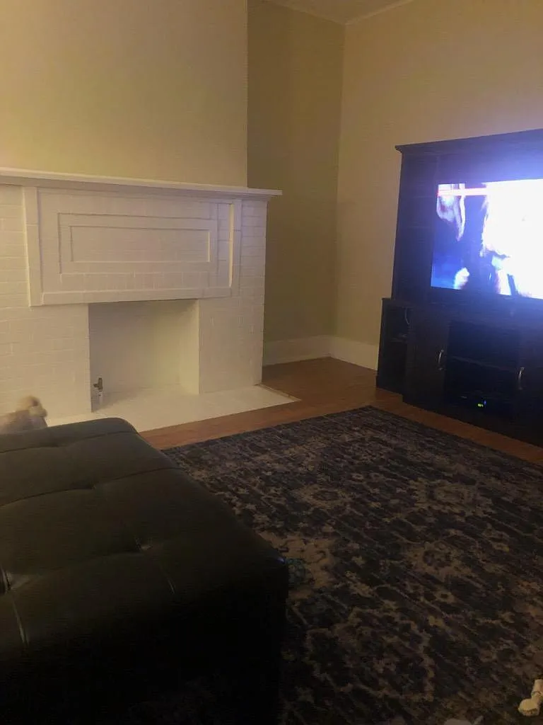 Living room, entertainment center included. - 1156 W 8th St