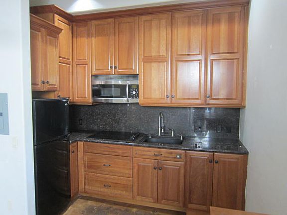 Full Size Kitchen, GE Profie Advantium Oven, full four burner cook top, plenty of storage in Solid Cherry Wood cabinets, granite slab countertop & back splash.