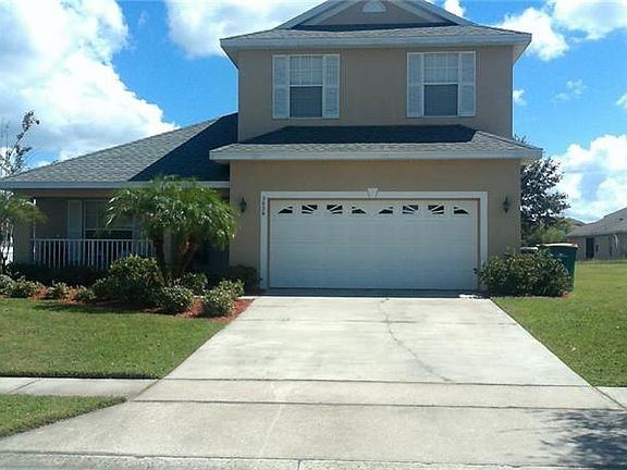 Front of home with mature landscaping and lovely curb appeal.