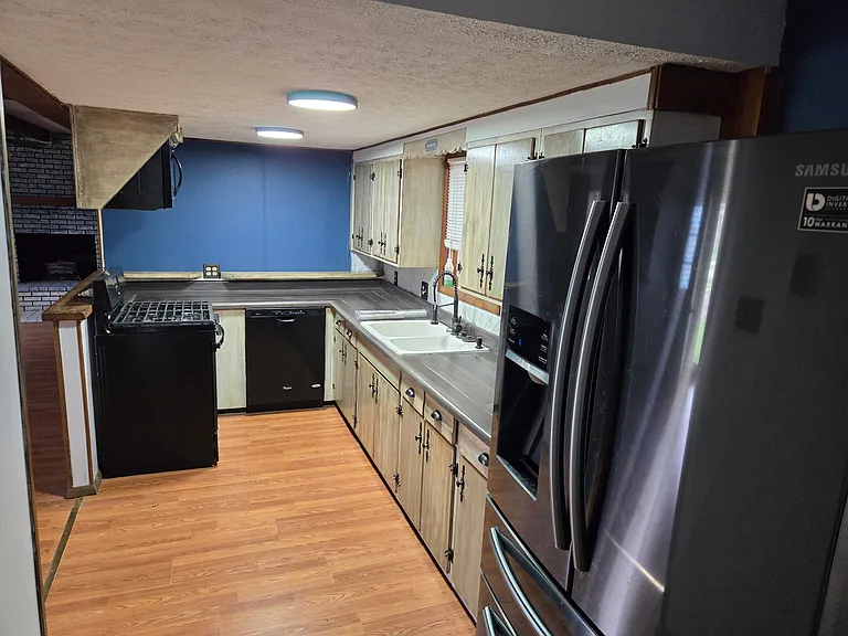 Matching appliances, deep sink with disposal, soap dispenser, led lighting and custom cabinet hardware.