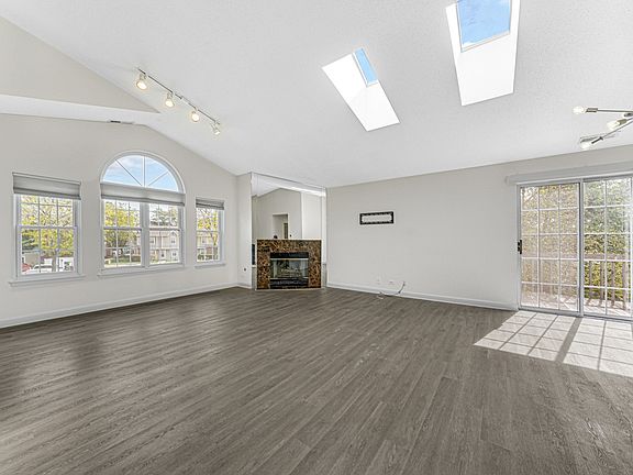Living Room: A spacious living area with comfortable seating, a coffee table, and decorative elements, also shown from various perspectives