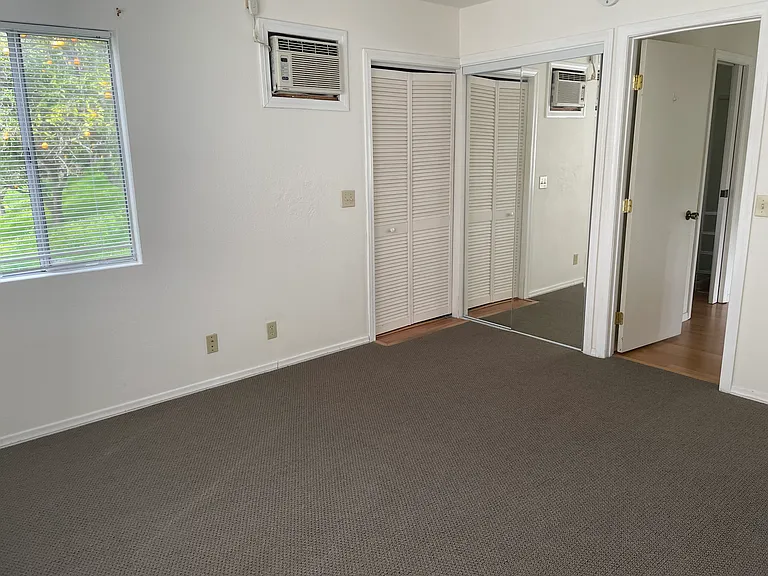 Looking back into bedroom, closet, and washer/dryer closet.