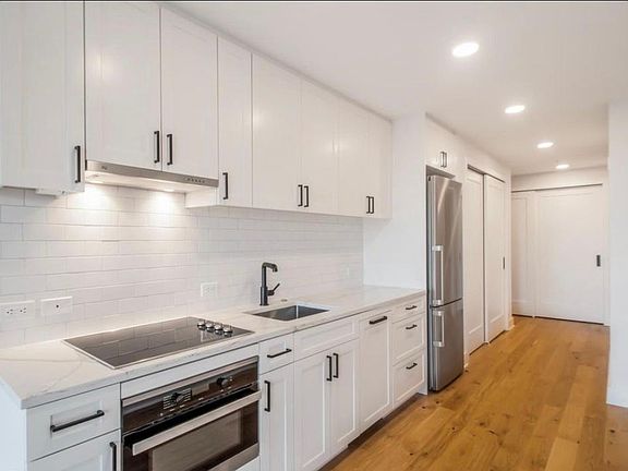 Custom quartz counter tops and fixtures. Brand new cooktop, fridge, dishwasher, 2-in-1 oven/microwave.