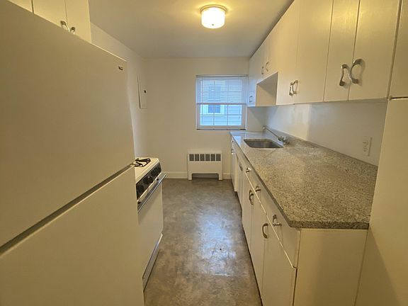 Kitchen w/gas stove & granite countertop; room for small table