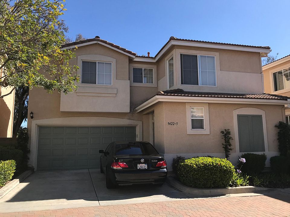 Detached unit with 2 car garage and a driveway that accommodates 2 more vehicles.