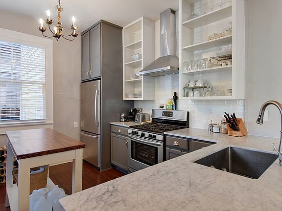 Kitchen with marble countertops and lots of windows