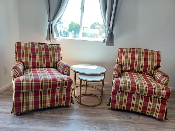 2 comfortable arm chair with 2 coffee tables. There's also seat cover which is not seen here. Window gives light and outdoor view of your car parked.