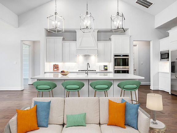 Kitchen island overlooks great room, virtually staged for demonstration