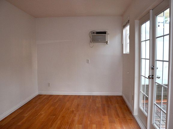 Newly installed custom French doors open up the back bedroom to natural lighting and outdoor patio space for morning coffee and more!