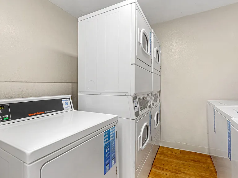 Relax and Refresh: Enjoy a cozy break in our communal laundry room, where clean floors and fresh paint set the stage for your ultimate comfort while your laundry gets done.