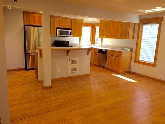 bright and open kitchen, open to main living area, with half bath off of main stairs.