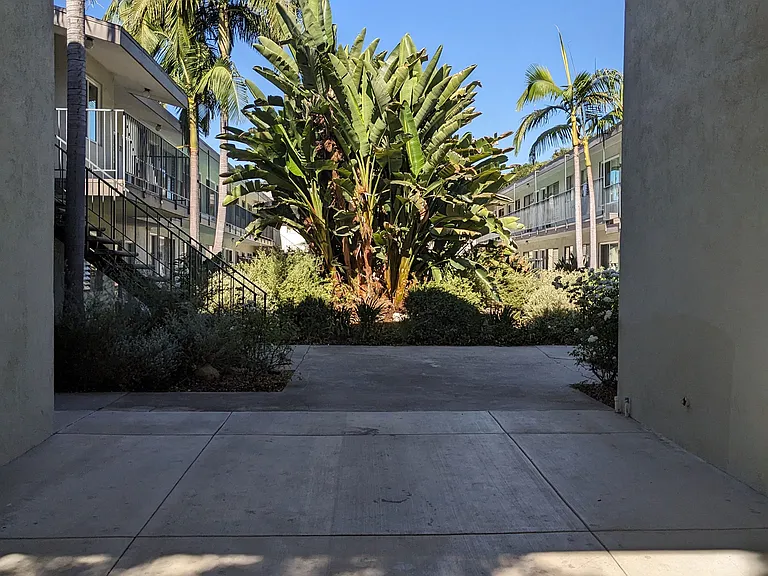 Lush trees and gardens in the courtyard of Los Robles Apartments in Pasadena, California.