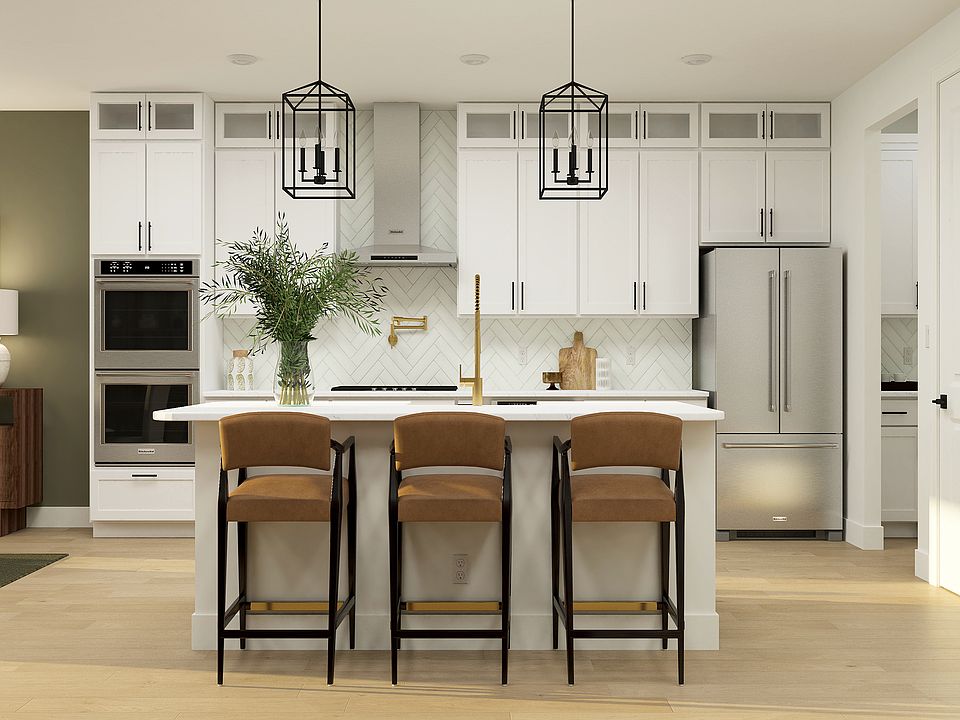 The beautiful kitchen has a large island and beautiful white wood cabinetry.