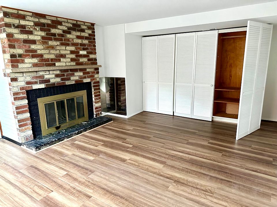 Master bedroom with fireplace and ample closet space
