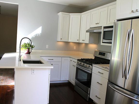 Plenty of kitchen storage and countertop eating plus eating area in corner of kitchen for table and chairs.