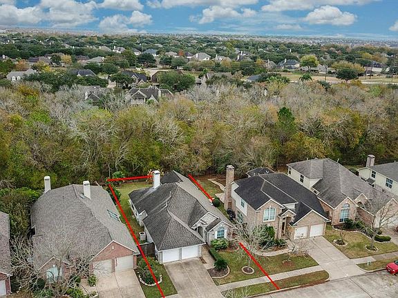 This aerial photo shows the wooded nature reserve behind the home with no back neighbor in view