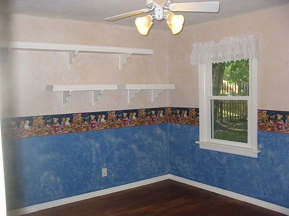 This bedroom shows the new windows and hardwood floors!