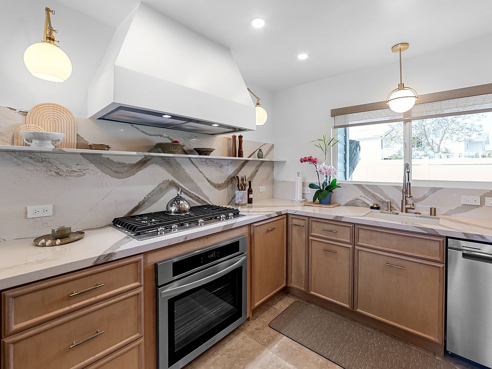 Gorgeous Cambria Quartz back splash and countertops, custom cabinetry, new window, window coverings, and new oven