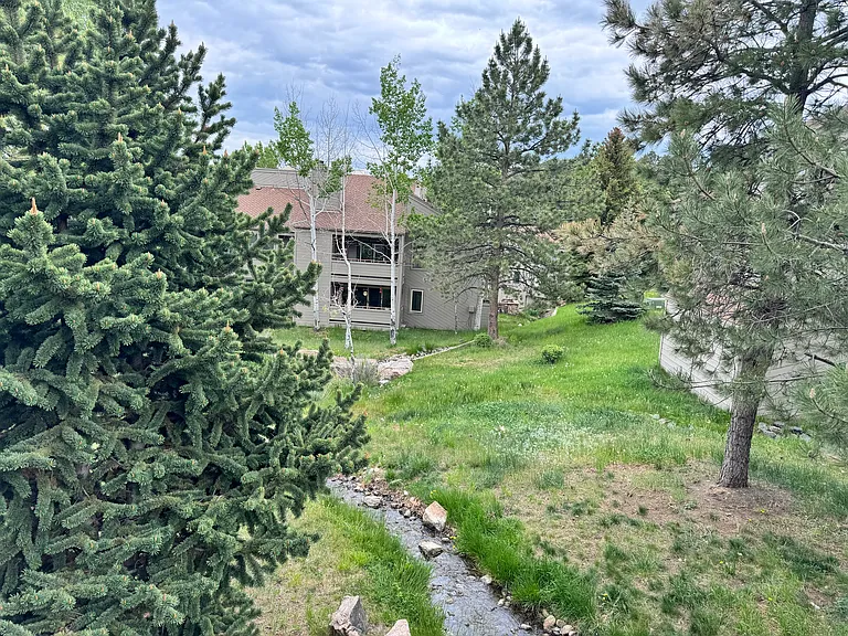 Rare Genesee Village condo surrounded by mature trees and the quiet beauty of the Colorado foothills.