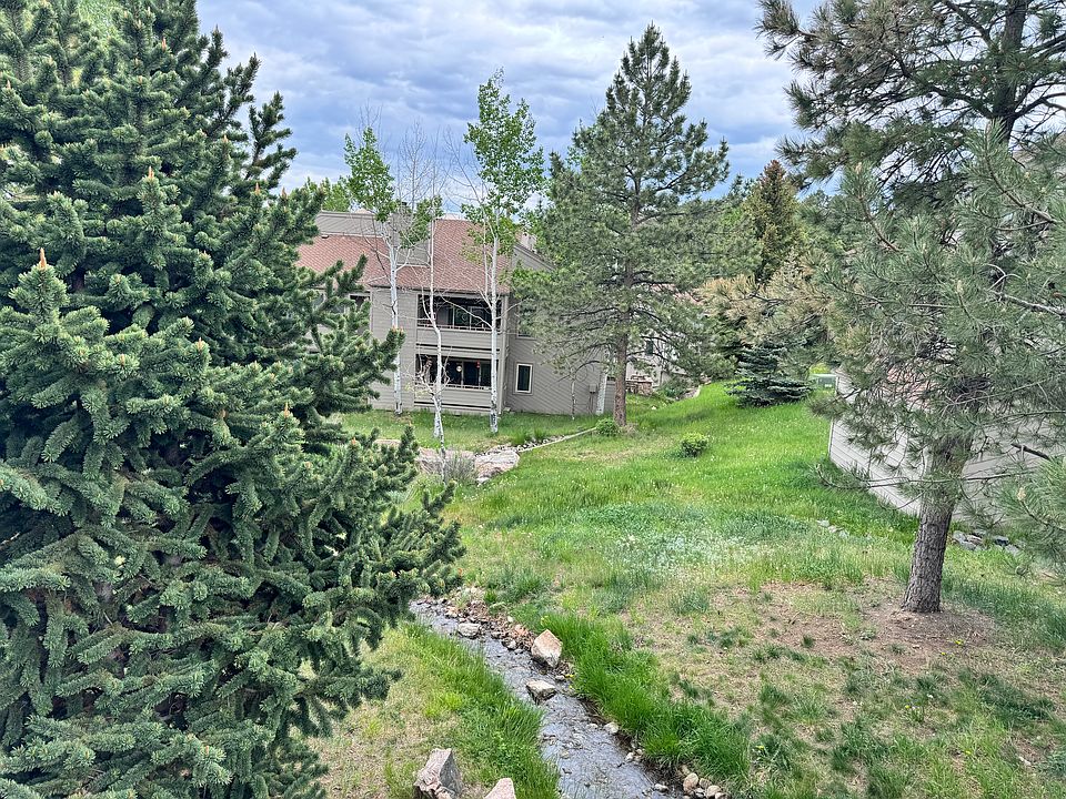 Rare Genesee Village condo surrounded by mature trees and the quiet beauty of the Colorado foothills.