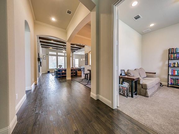 Hardwoods from entry throughout living areas.  Five inch baseboards, crown and tall ceilings! Glass doors lead to study.