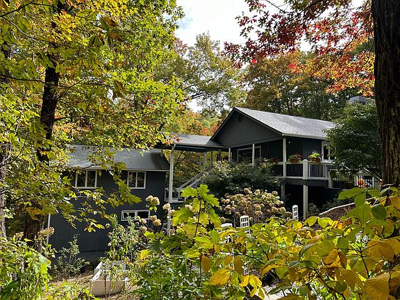 1.5 acres property with 2 homes. The small executive apartment is in the left side smaller building lower level. Stairs are involved and the property is uneven on the side of a mountain.