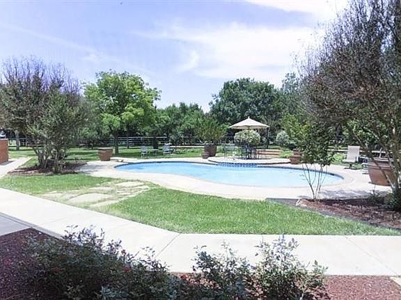 Lush irrigated landscaping, manicured, mulched beds, fruit trees, simply gorgeous grounds.